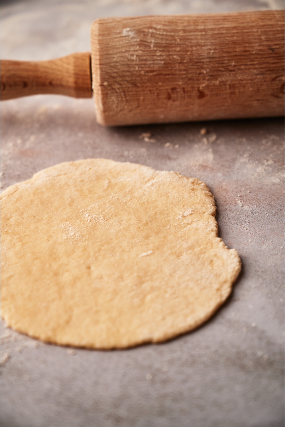 A rolled out piece of dough on a table.