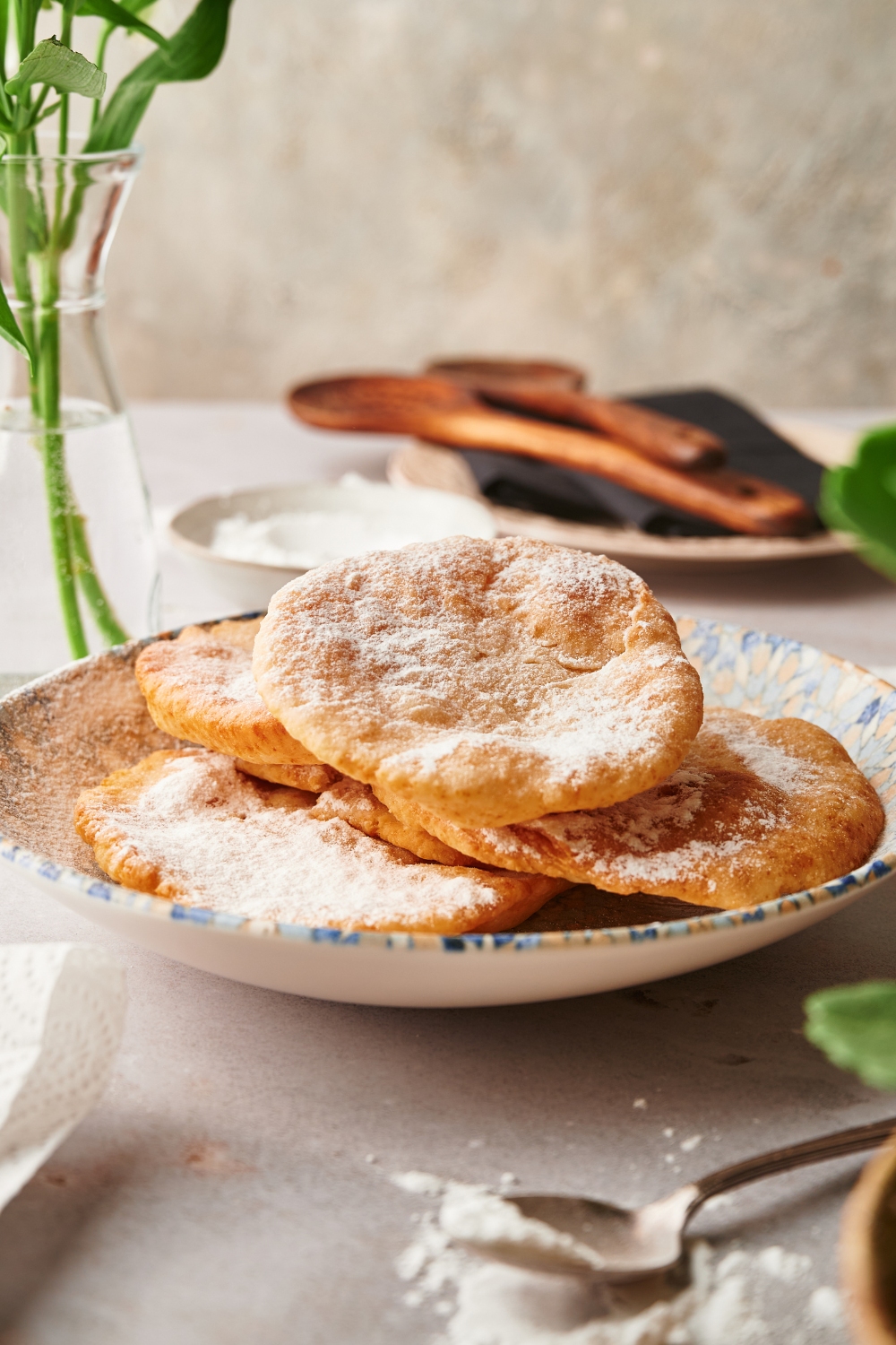 A bunch of pieces of fried dough on top of one another on a plate.