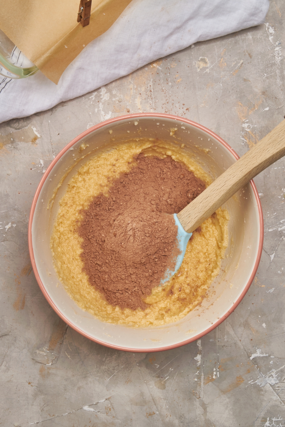 A mixing bowl with the dry ingredients being added to the creamed ingredients.
