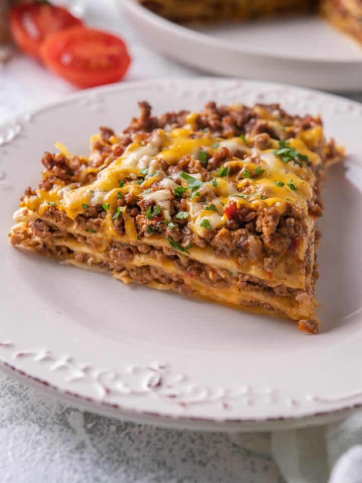 A plate with a slice of taco casserole on it.