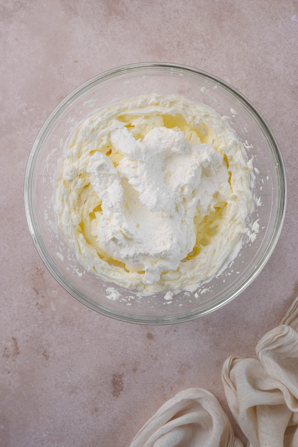 A mixing bowl with the mixed cream cheese filling ingredients; whipped topping has just been added.