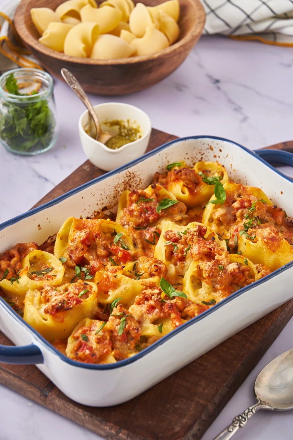 Freshly baked stuffed shells covered in golden brown melted cheese and garnished with fresh basil.