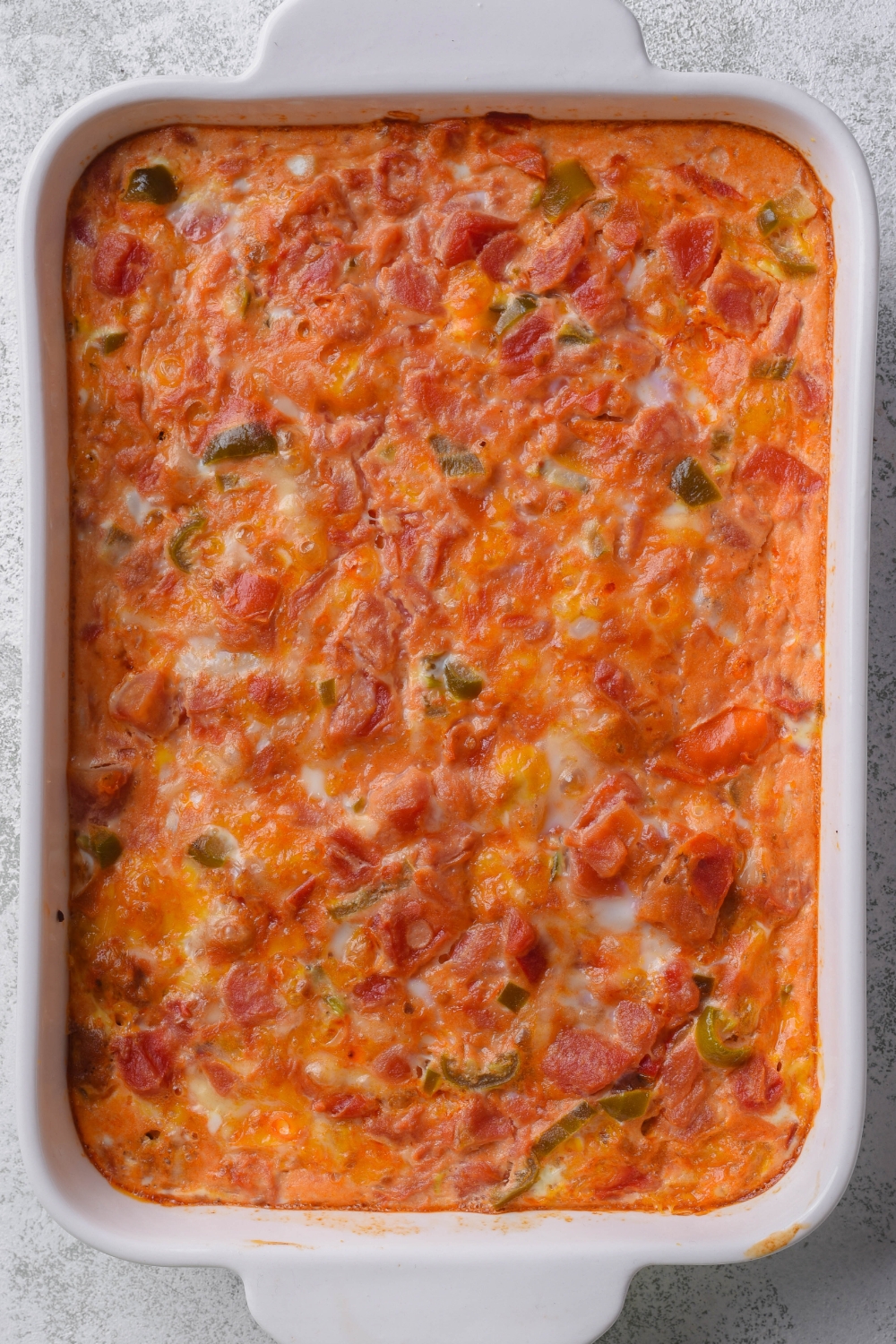 A baking dish with baked Mexican casserole in it.