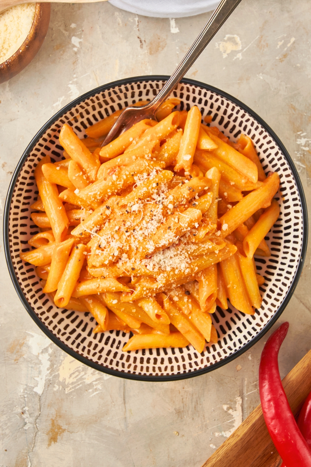 Spicy rigatoni vodka pasta in a bowl with a fork in it.