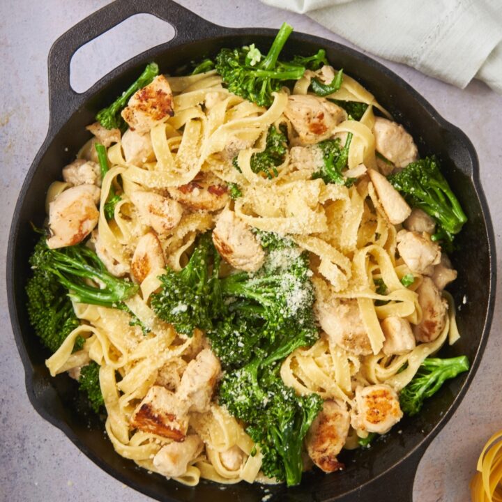 A skillet filled with chicken broccoli alfredo.