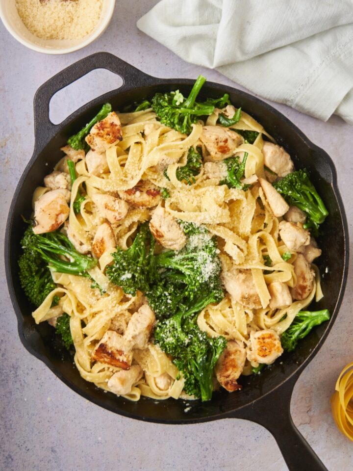 A skillet filled with chicken broccoli alfredo.
