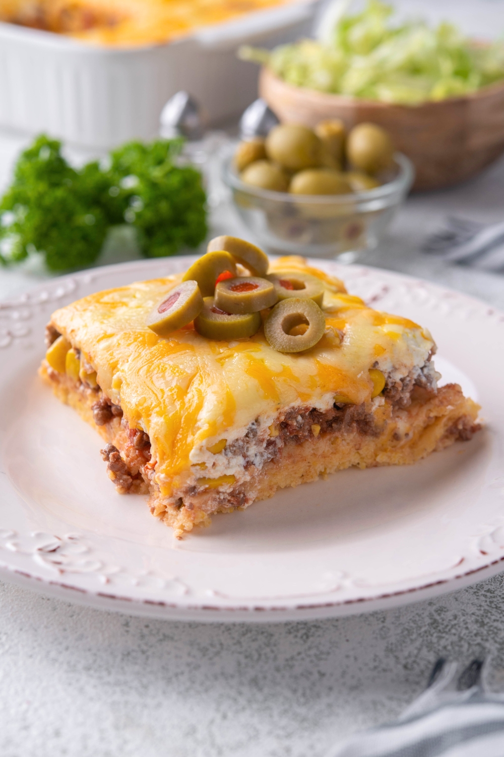 A square of cornbread taco bake on a white plate.