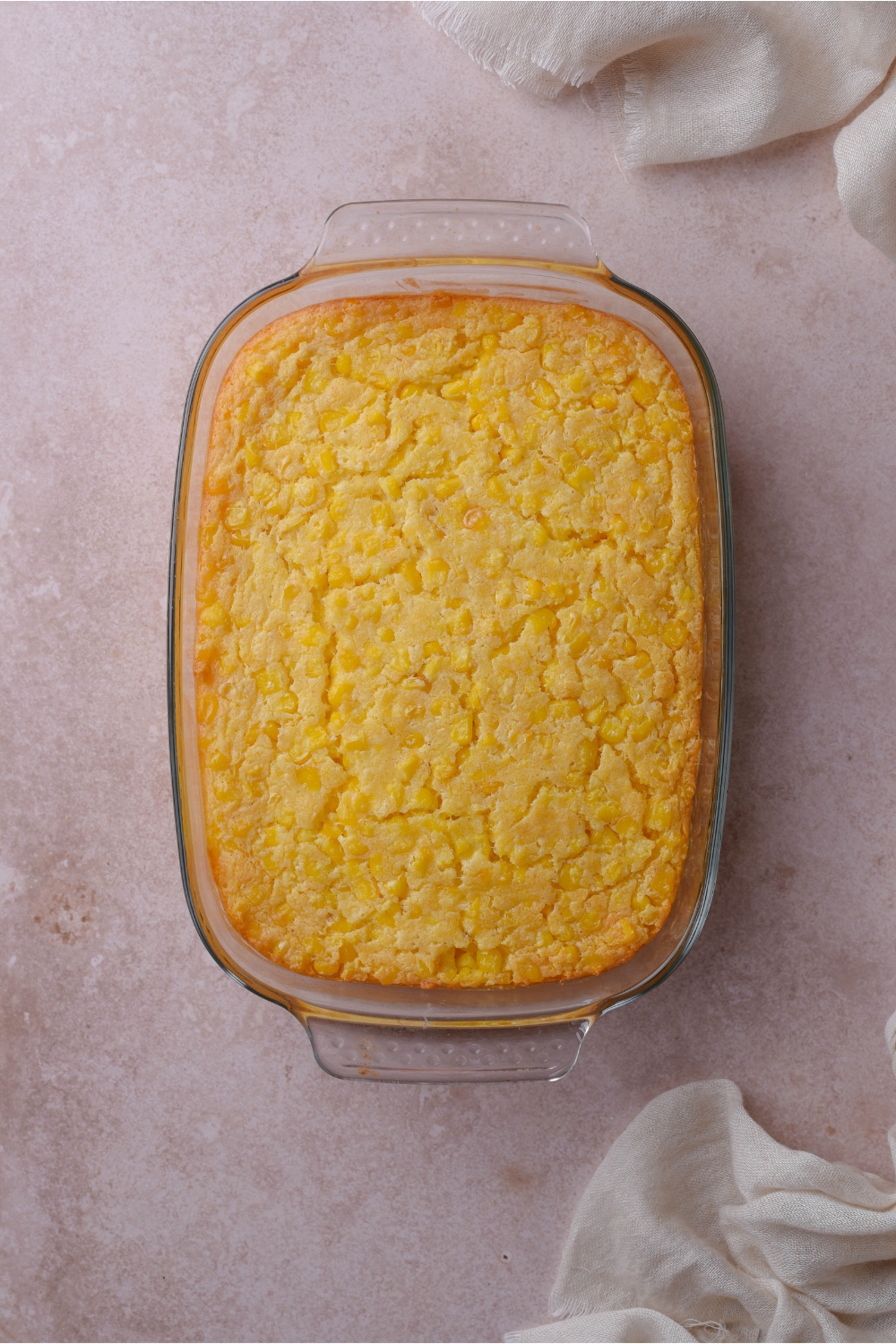 A baking dish filled with freshly baked corn casserole.
