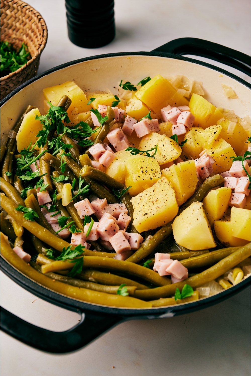 A pot with ham, green beans, and diced potatoes.