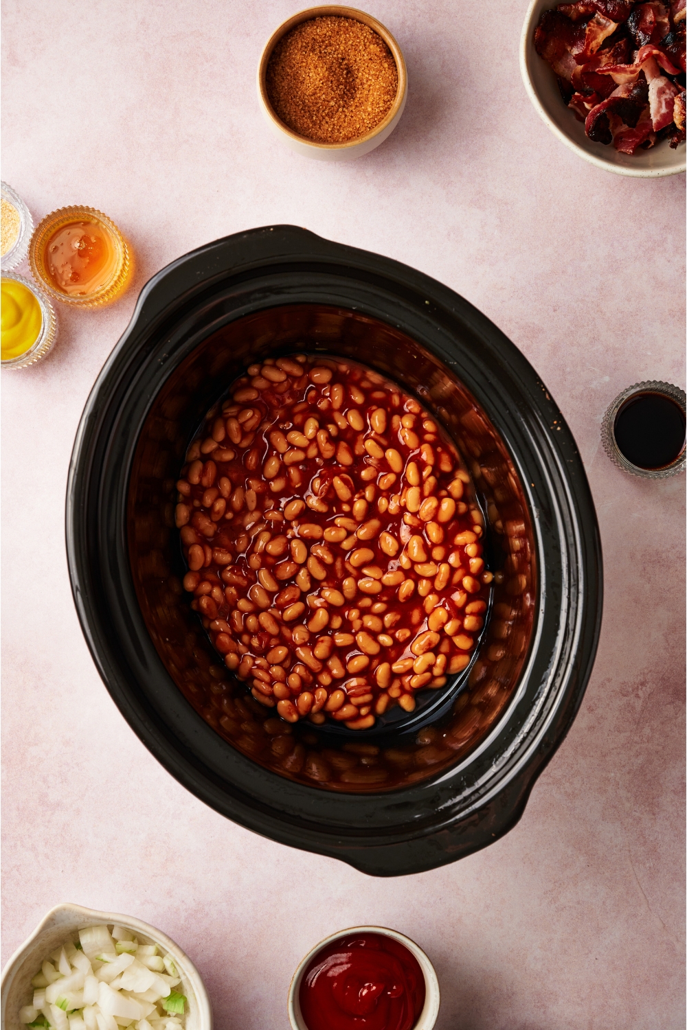 A crock pot filled with canned beans.
