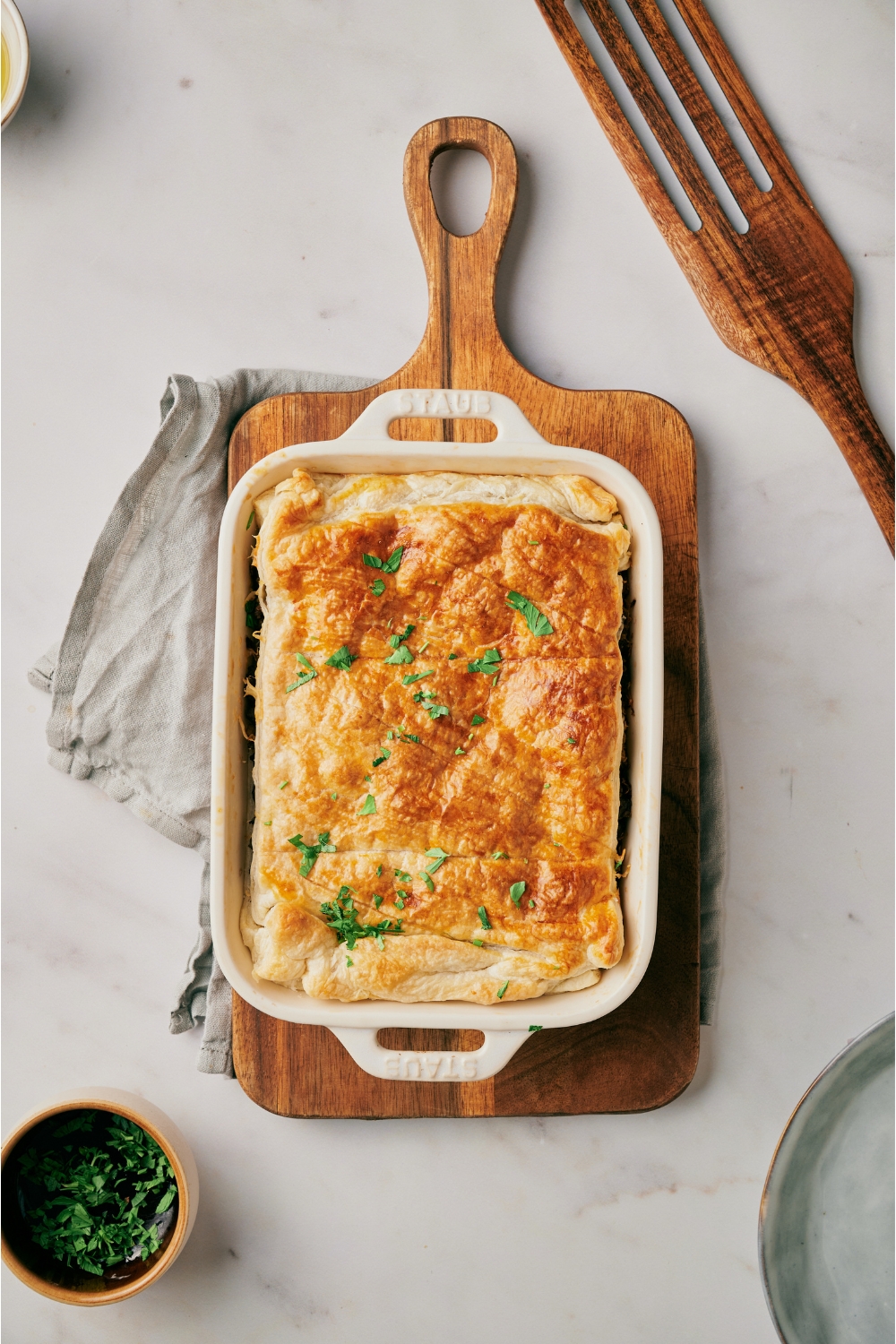 Freshly baked Runza casserole covered with golden brown crescent dough and fresh green herbs.