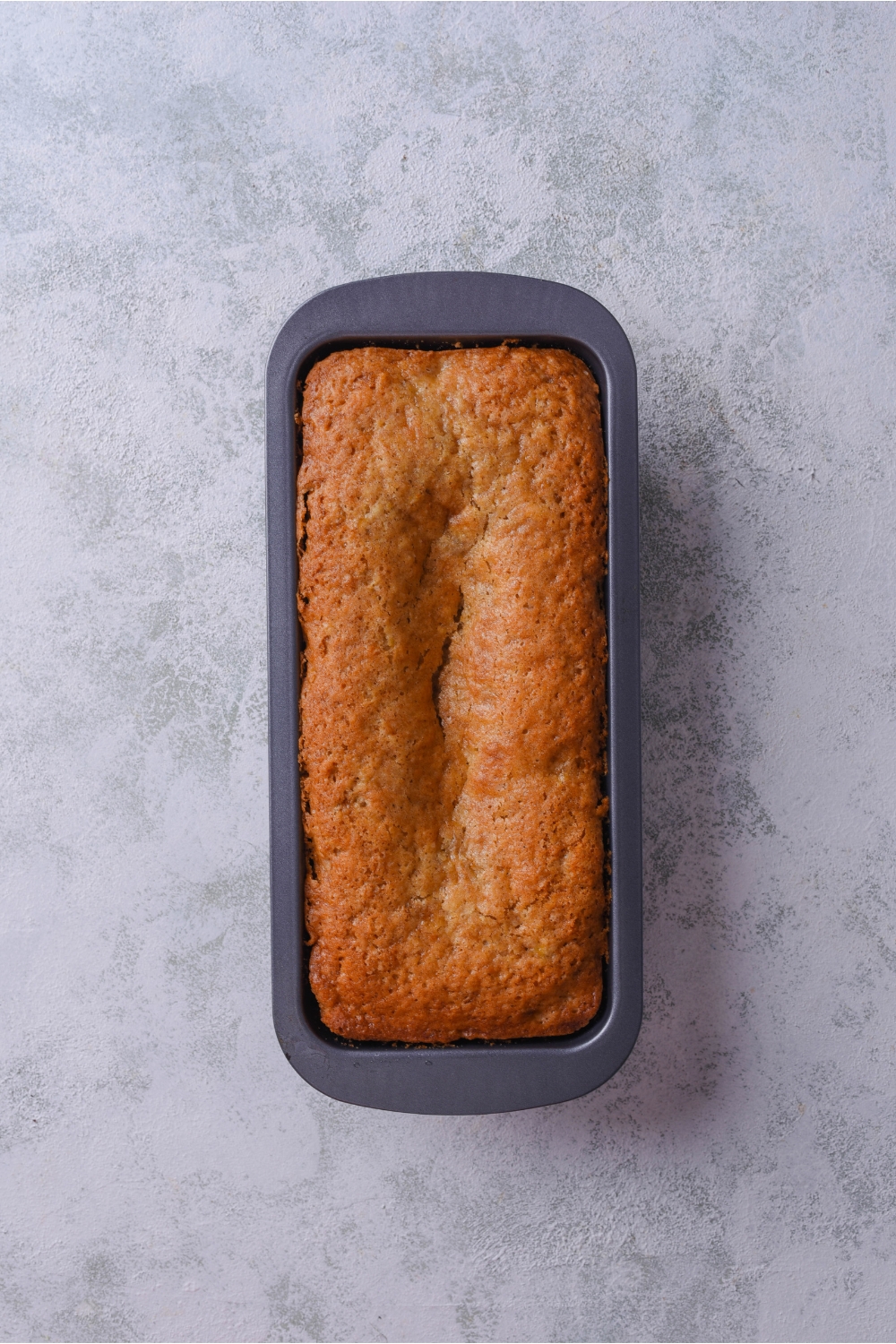 A loaf pan filled with freshly baked banana bread.