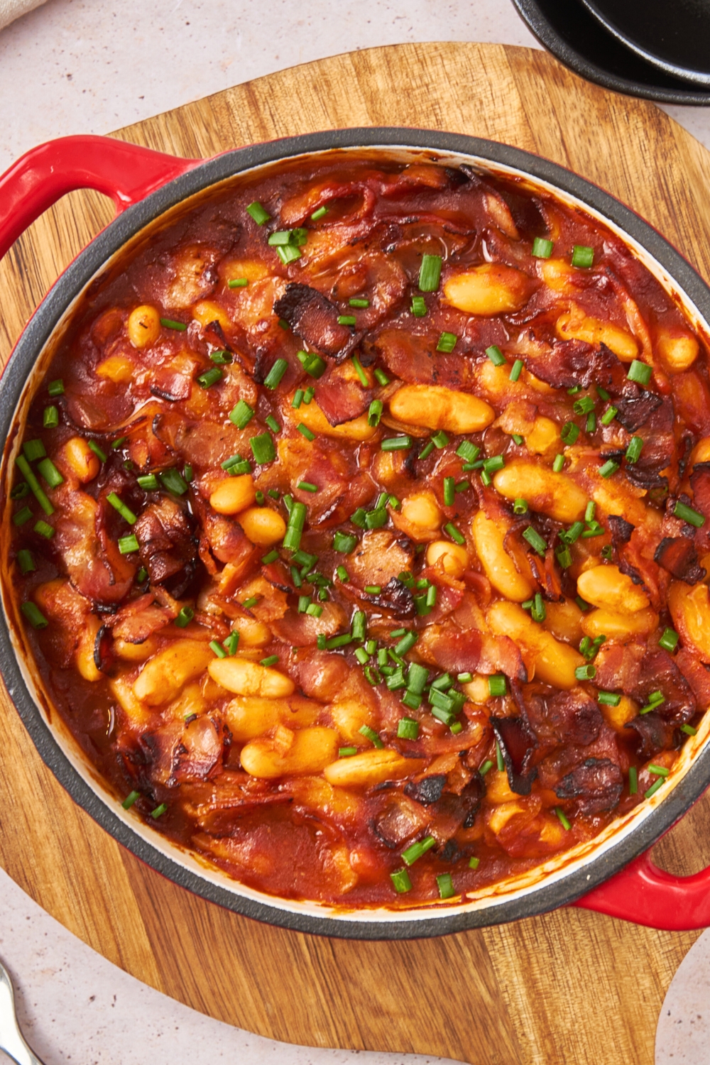 Baked bean casserole in a round baking dish.