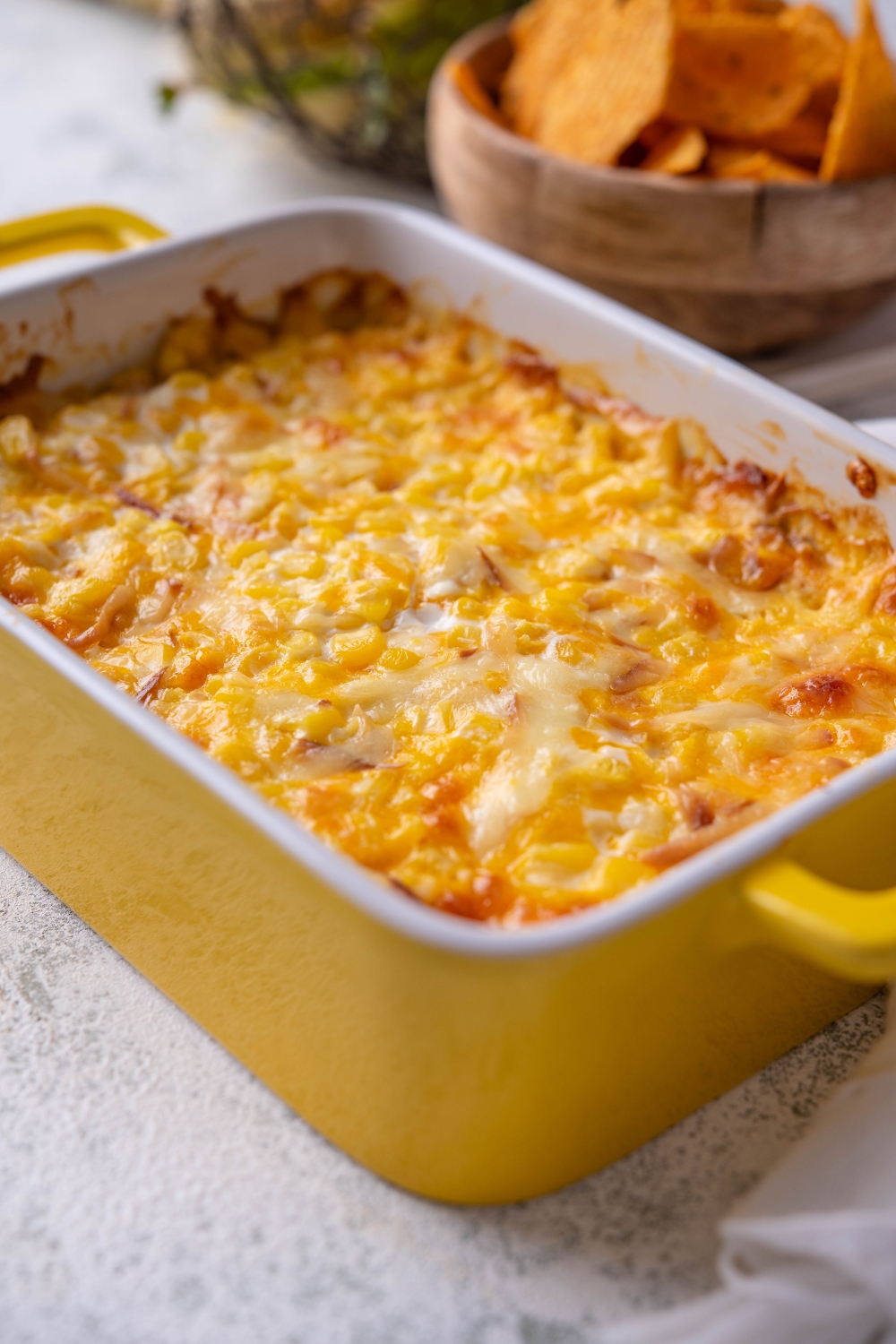 A baking dish with baked corn dip.