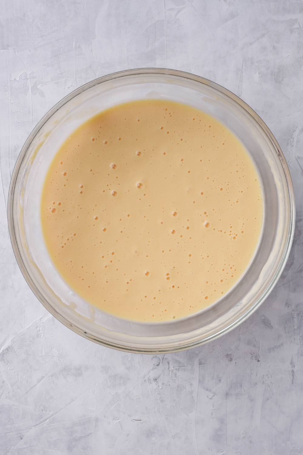 A mixing bowl with crepe batter in it.