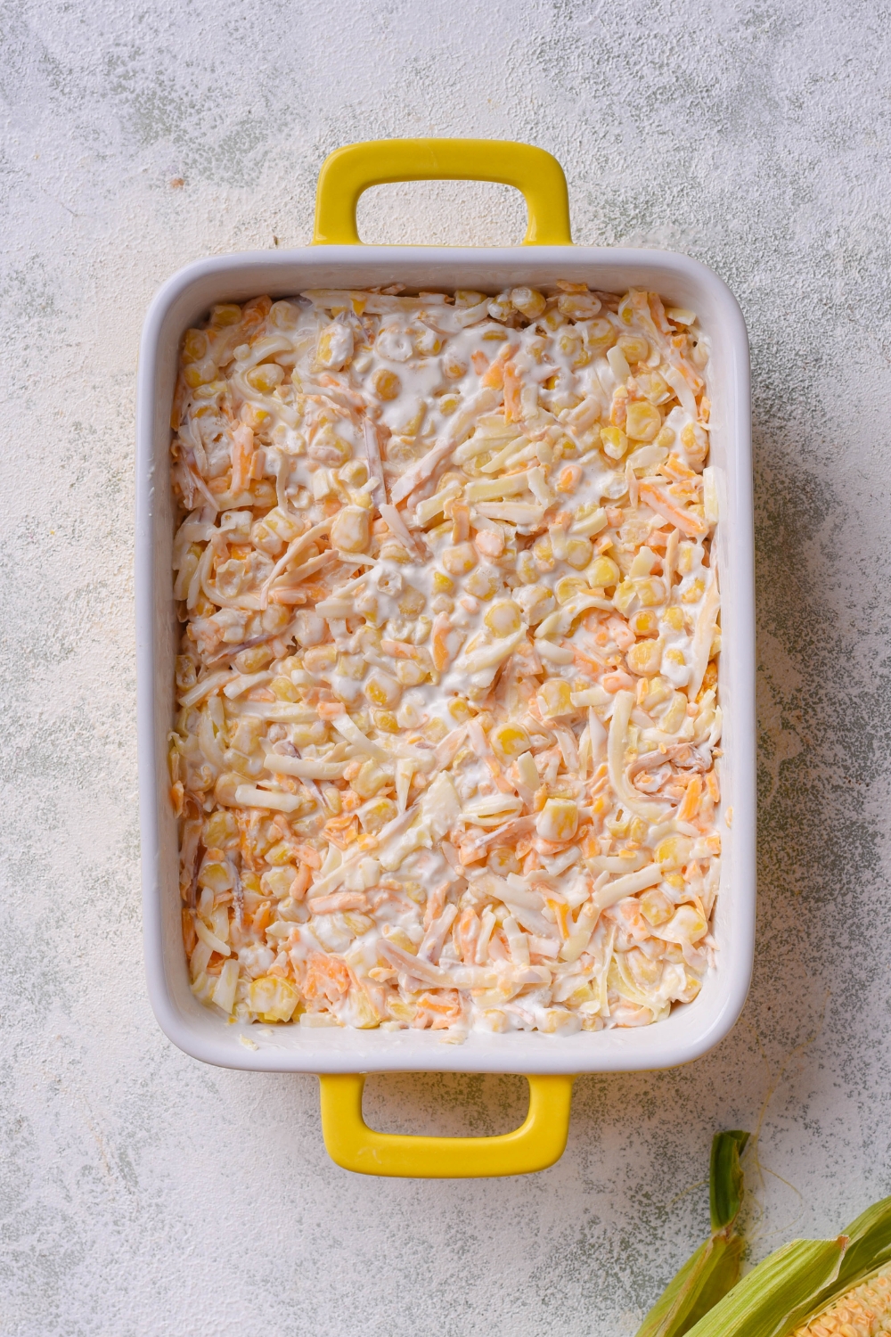 A baking dish with unbaked corn dip.