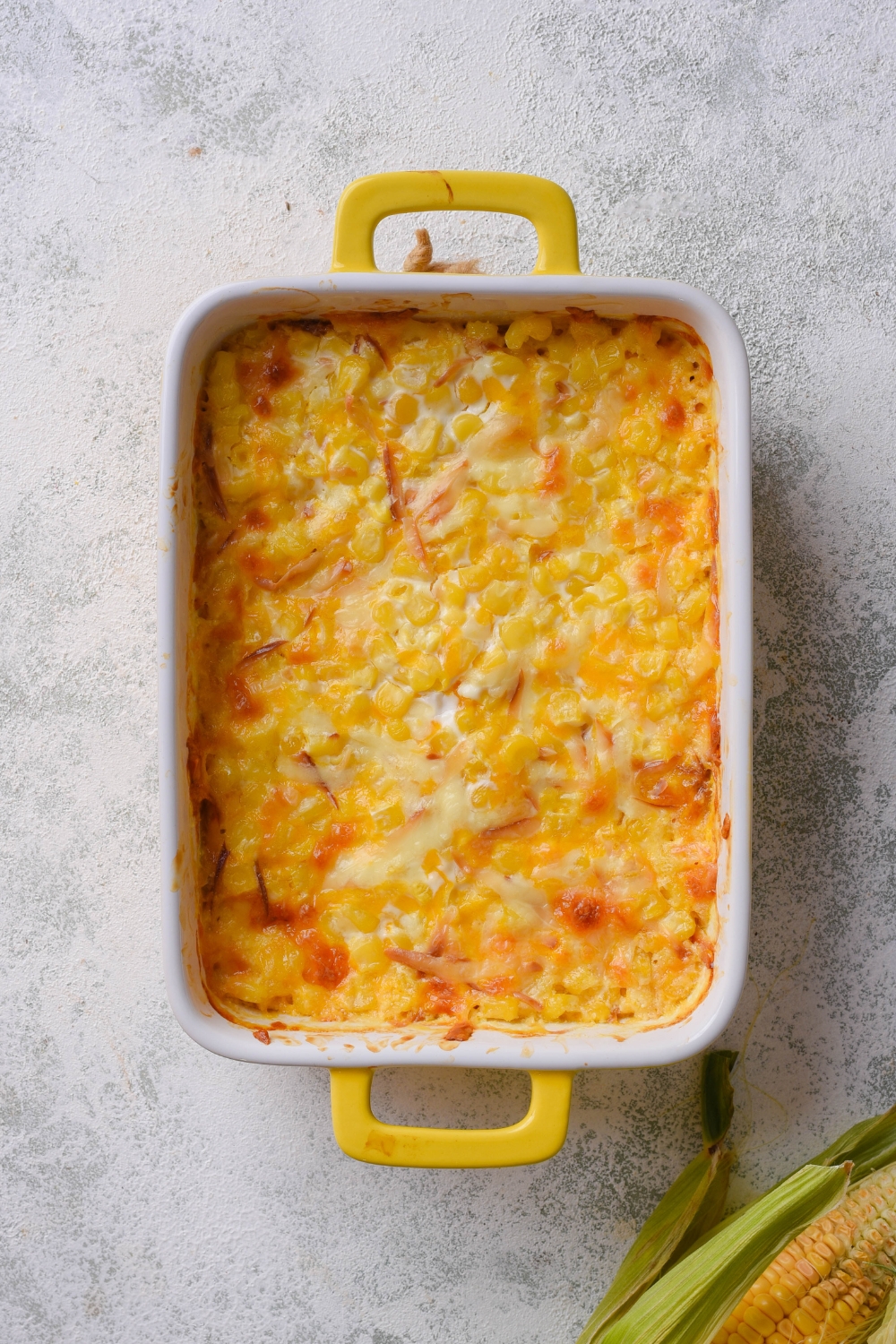 A baking dish with corn dip baked to perfection.