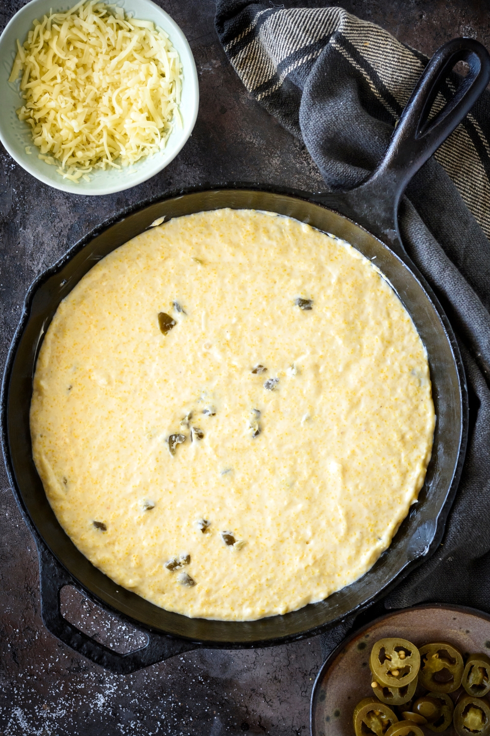 Jiffy jalapeno cornbread batter in a cake pan.