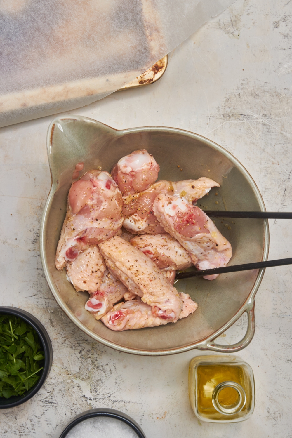 Seasoned salt and pepper chicken wings in a bowl.