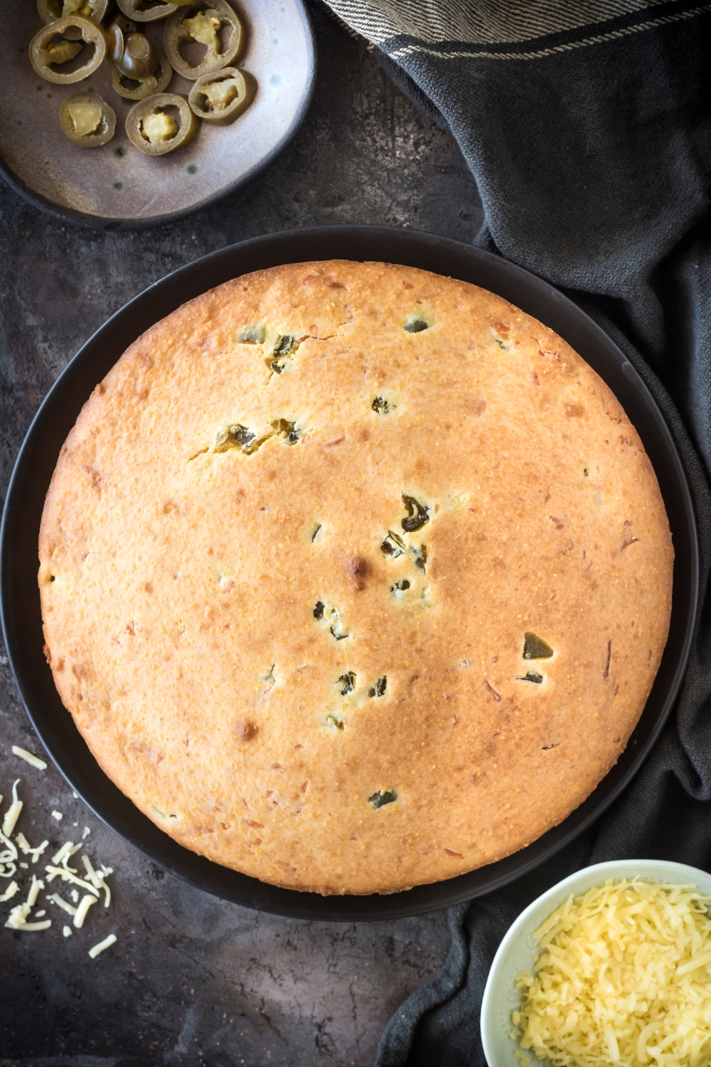 Top view of baked Jiffy jalapeno cornbread in a cake pan.