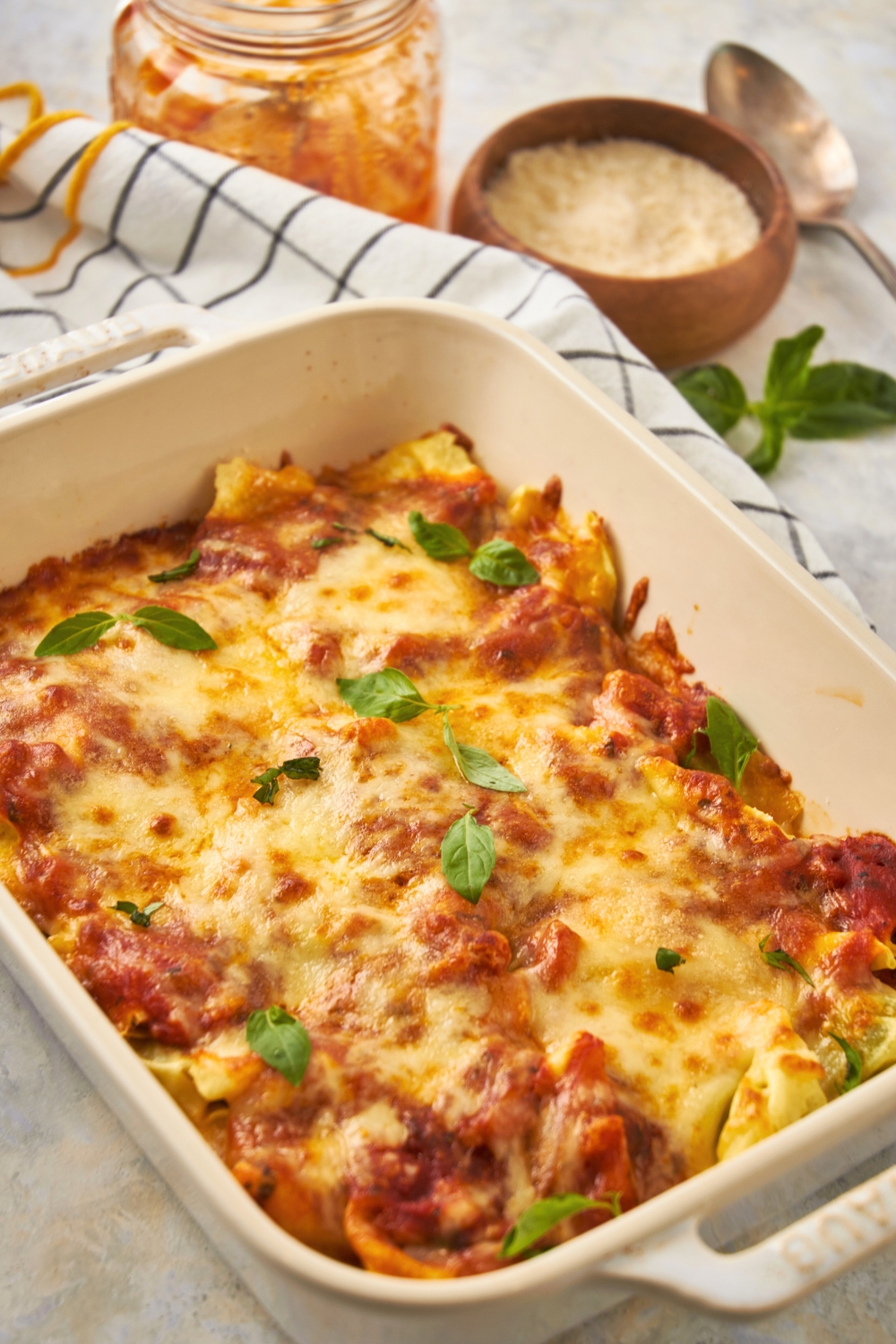 A baking dish filled with cheesy baked tortellini.