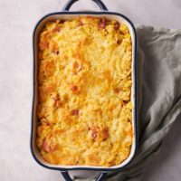 A baking dish filled with freshly baked corn dog casserole.