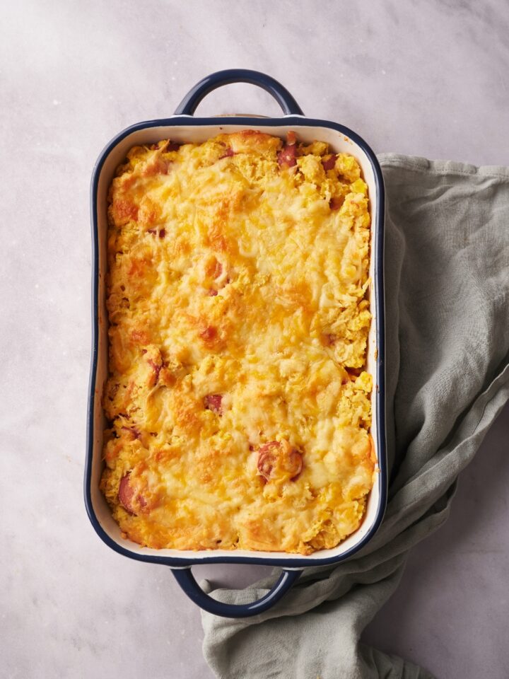 A baking dish filled with freshly baked corn dog casserole.