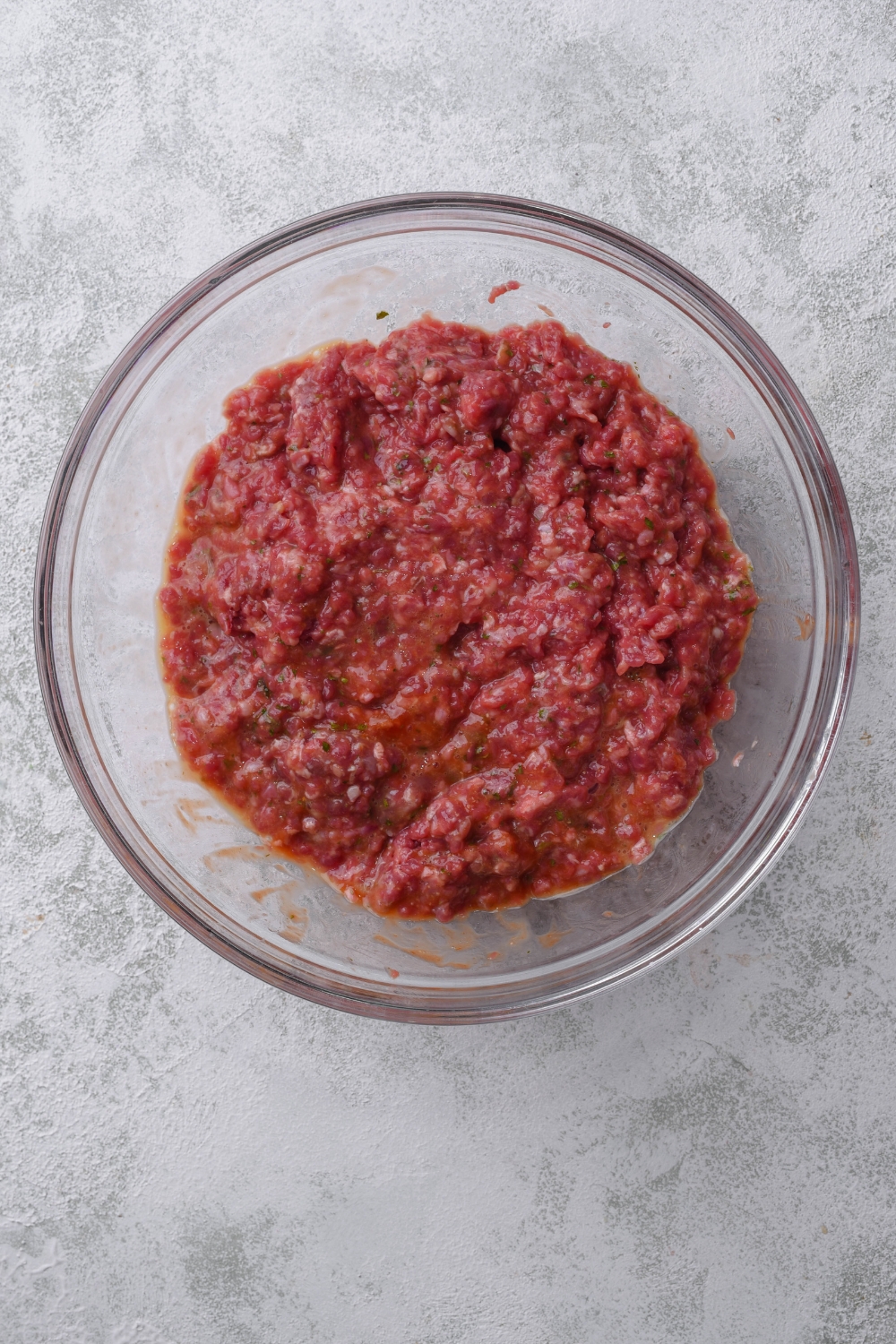 A clear bowl filled with a ground beef mixture.