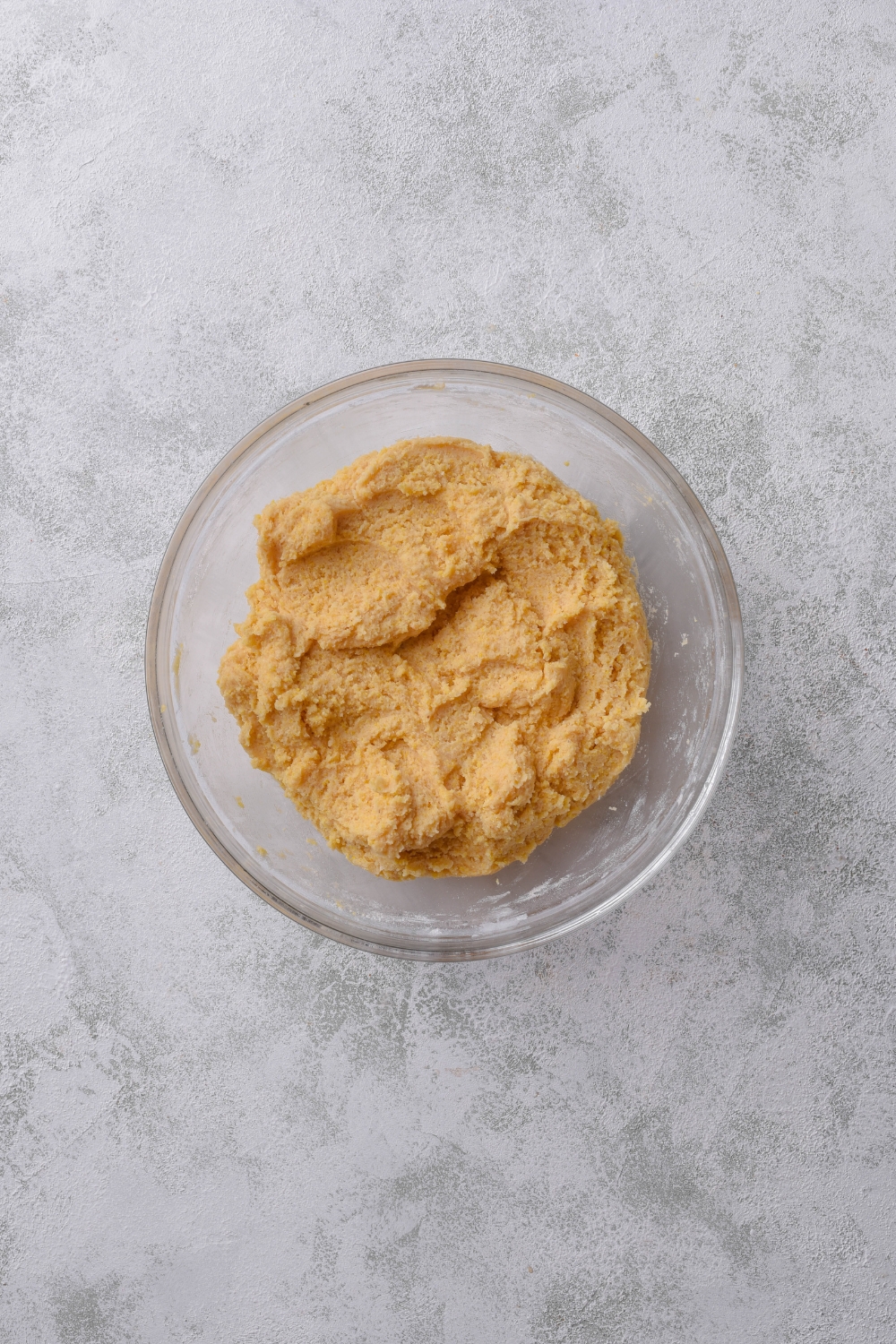 A clear mixing bowl filled with cookie dough.