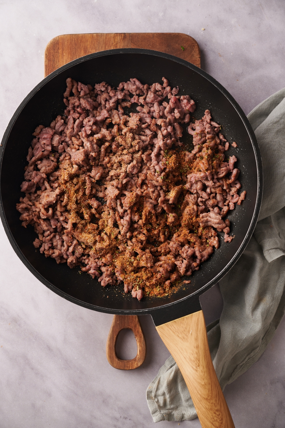 A skillet filled with cooked and seasoned ground beef.