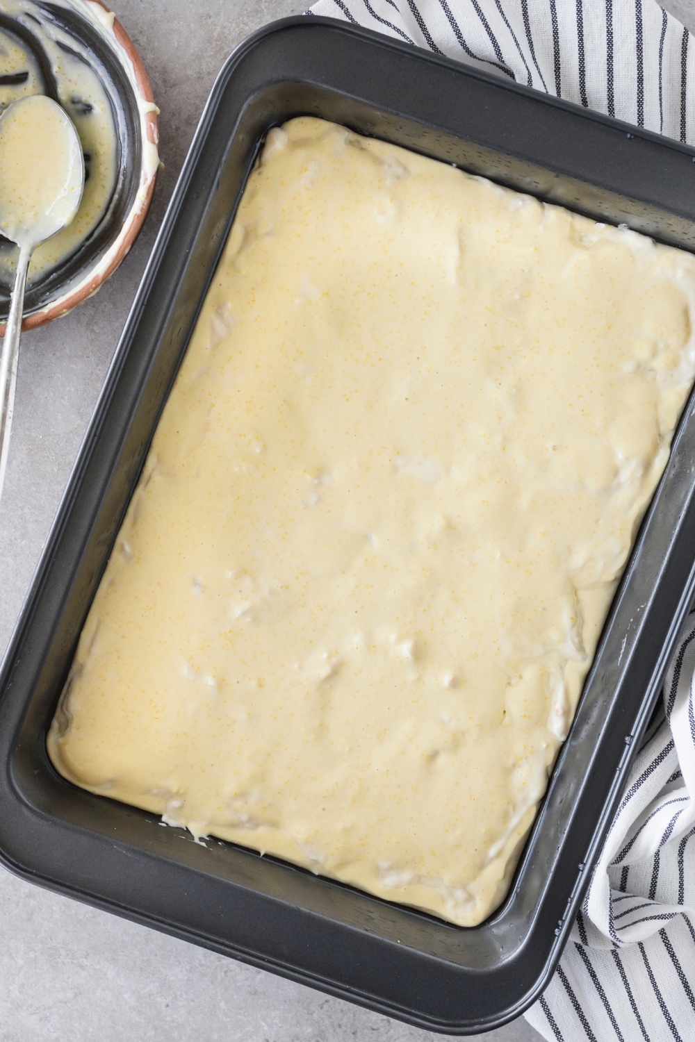A baking dish filled with unbaked casserole.