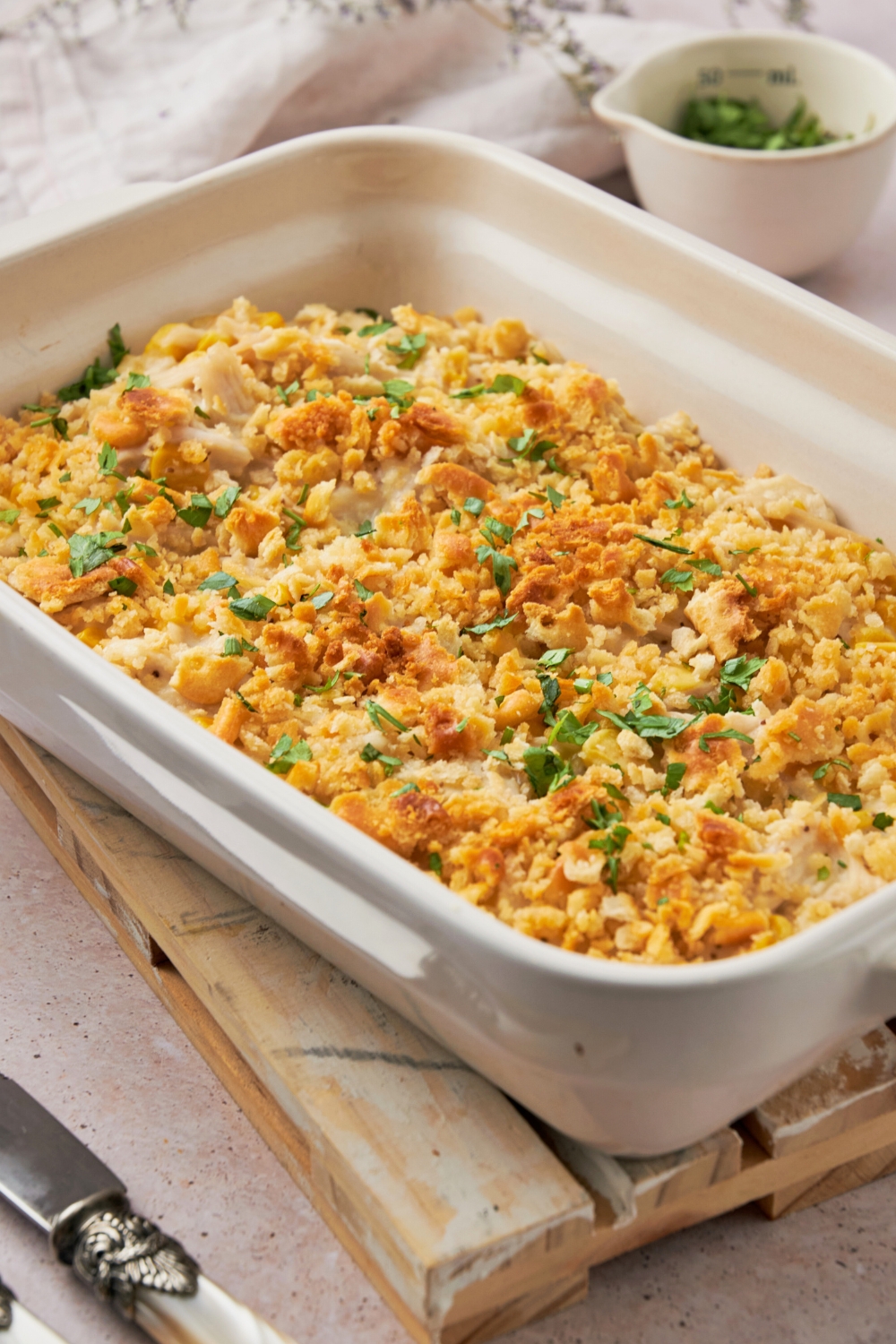 A white casserole dish filled with amish chicken casserole.