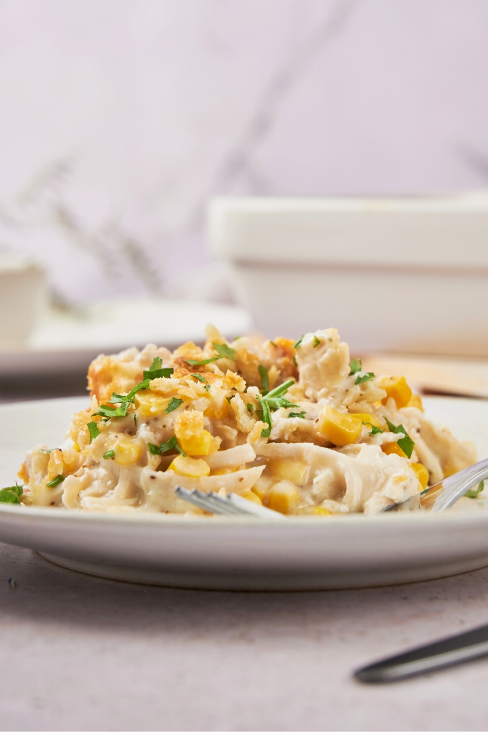 Amish chicken casserole on a white plate on a white counter.