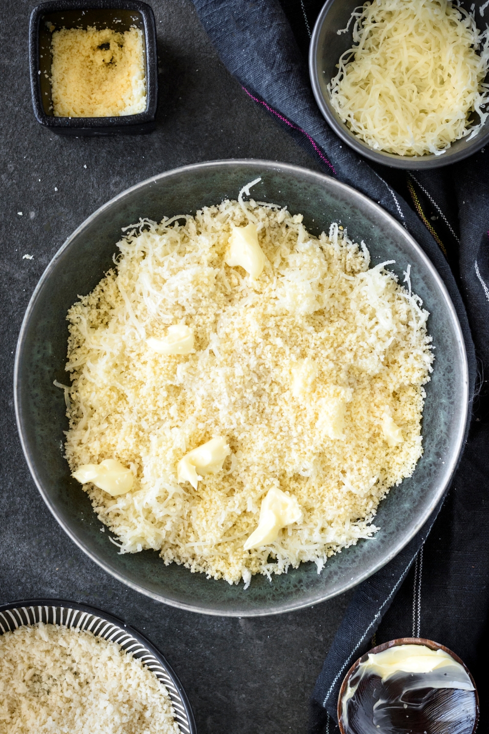 A mixing bowl with the bread crumb and cheese topping.