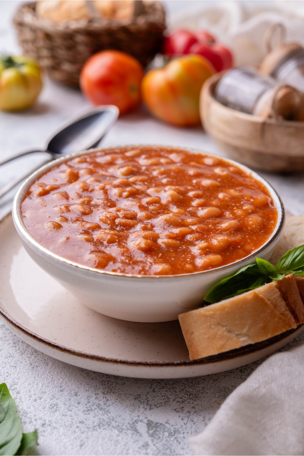A bowl of baked beans served with bread slices.