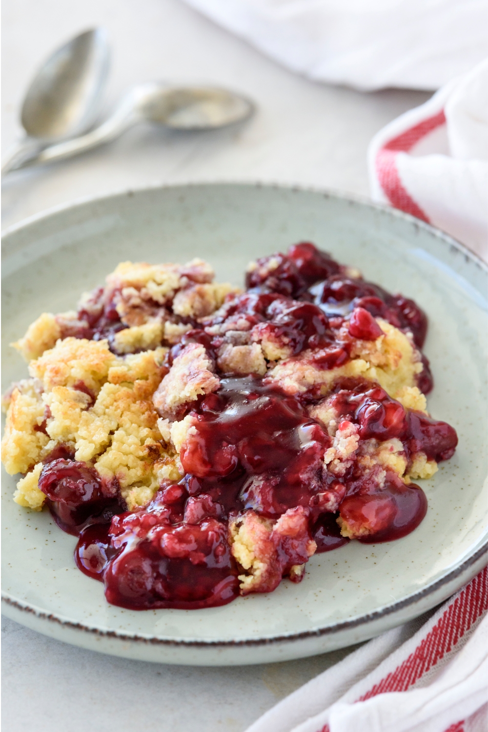 A plate with cherry dump cake.