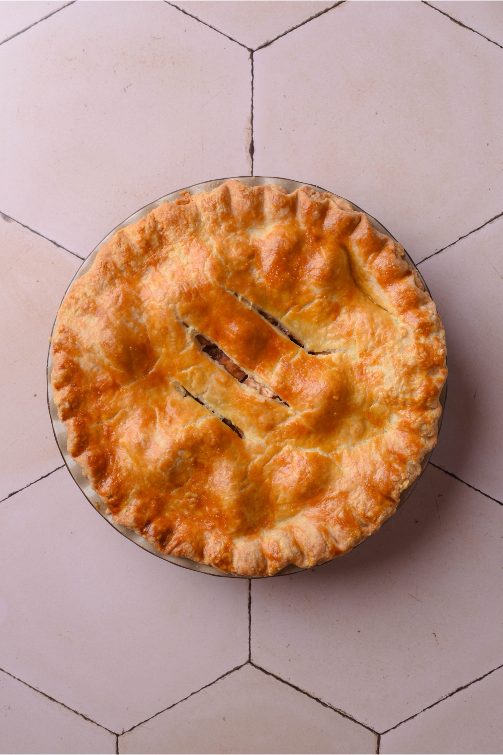 A pie pan with baked apple pie.