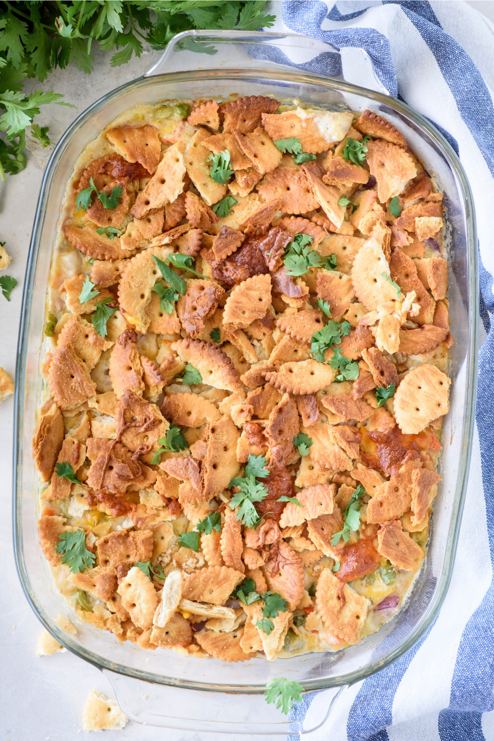 A casserole dish with baked casserole topped with chopped cilantro.