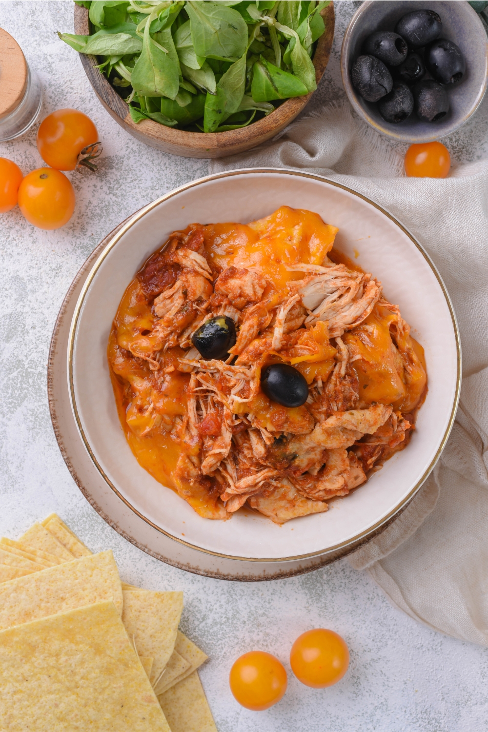 An overhead view of a bowl with crockpot chicken enchiladas.