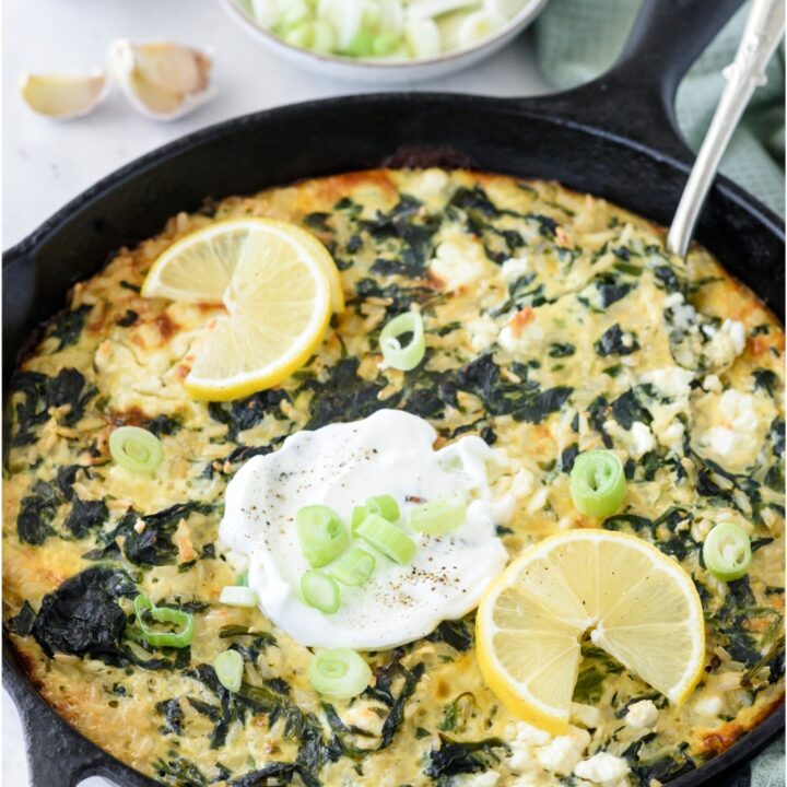A skillet with spinach rice casserole.