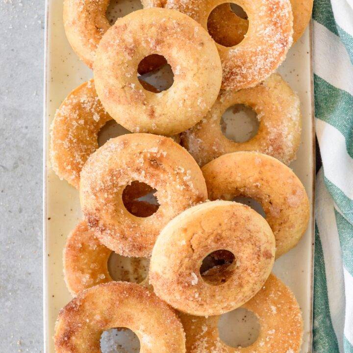 A pile of doughnuts covered in cinnamon sugar.