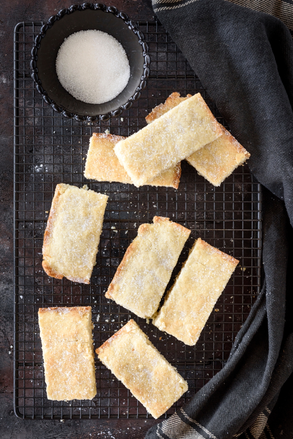 Rectangular biscuits on a cooling rack sprinkled with sugar.