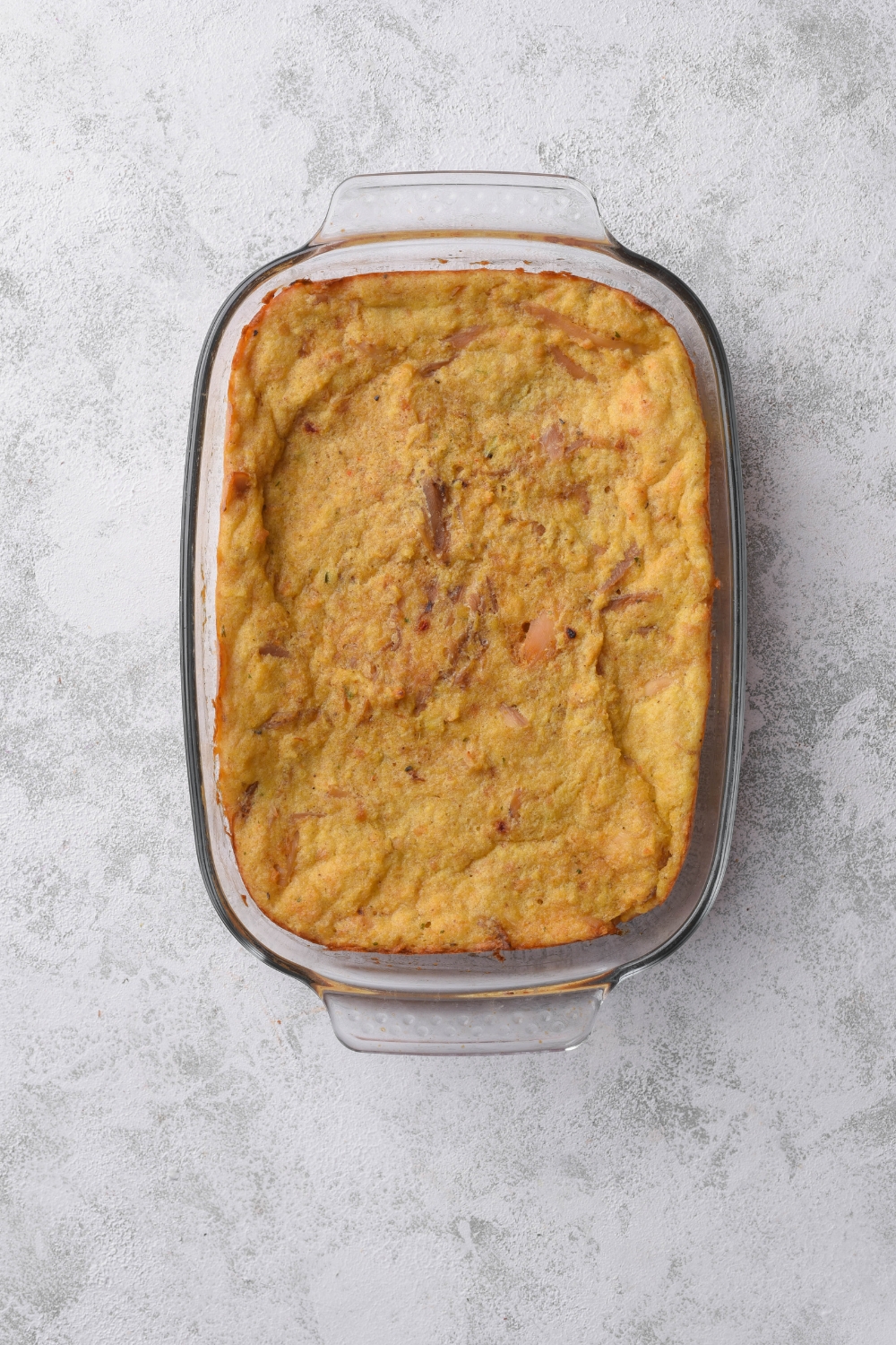 A clear baking dish filled with freshly baked casserole.