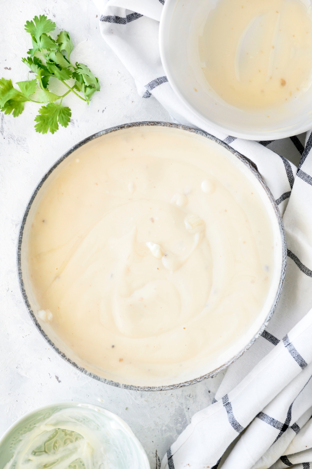 A bowl filled with a creamy sauce.