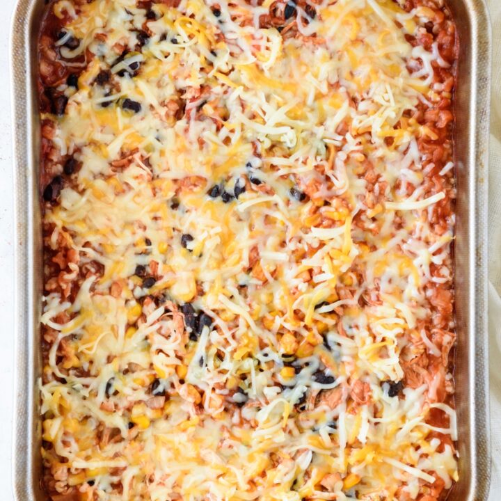 A baking dish filled with freshly baked southwest chicken casserole covered in melted cheese.