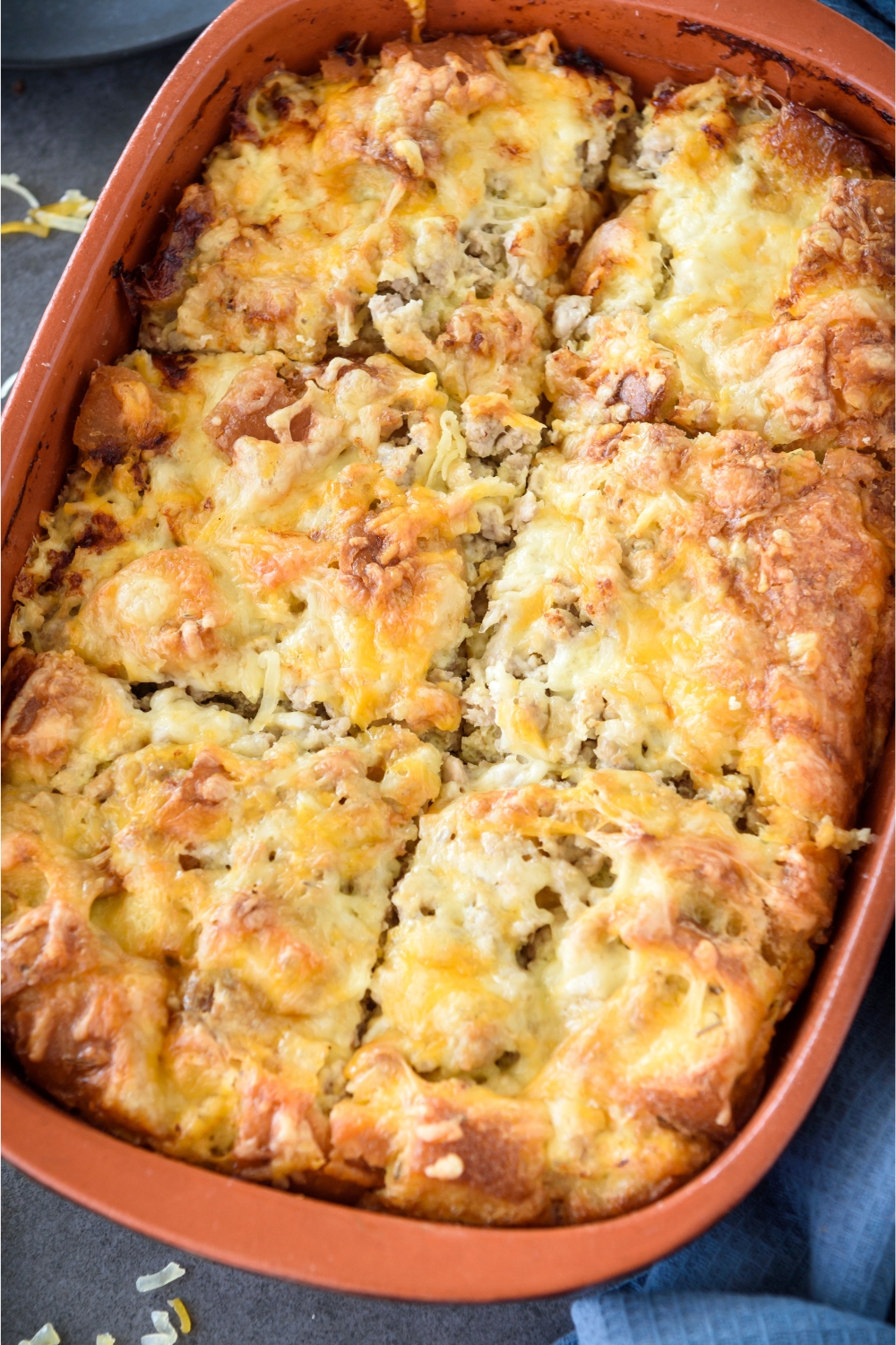 A baking dish filled with casserole that's been cut into six equal-sized pieces.