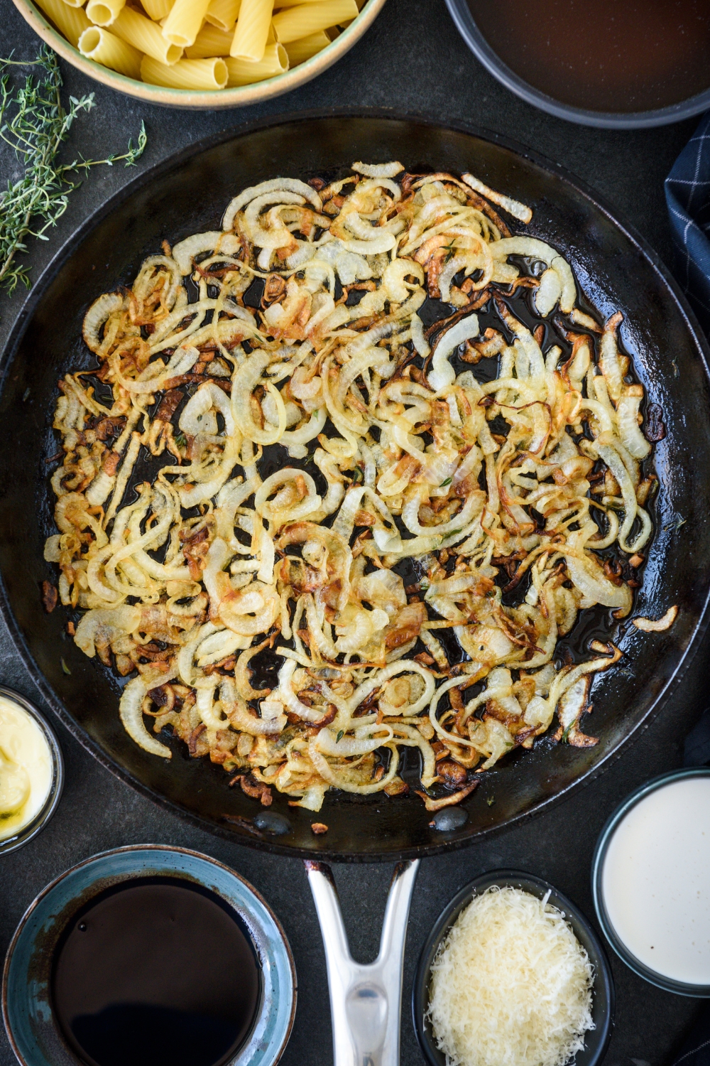 A skillet filled with onions browning in it.