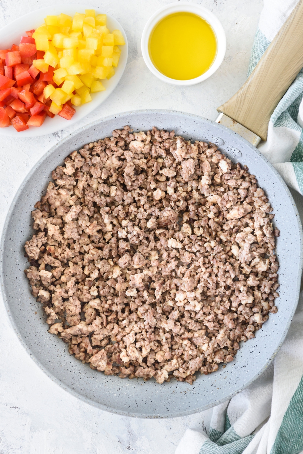 A skillet filled with cooked ground beef.