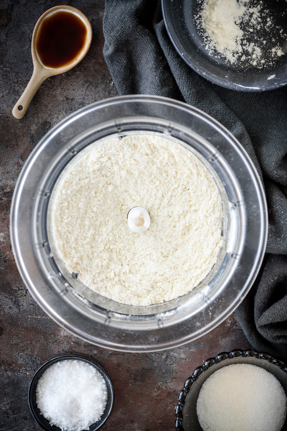 A food processor with flour in it.