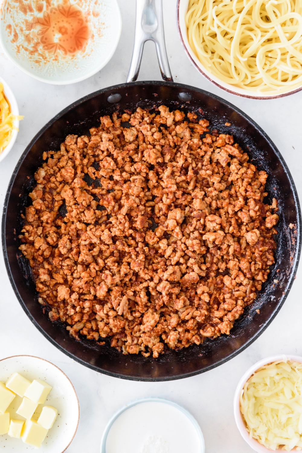 A skillet filled with cooked and seasoned ground meat.